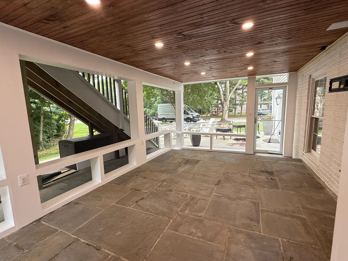 Interior of a finished screened porch with wood ceiling in Northern Virginia